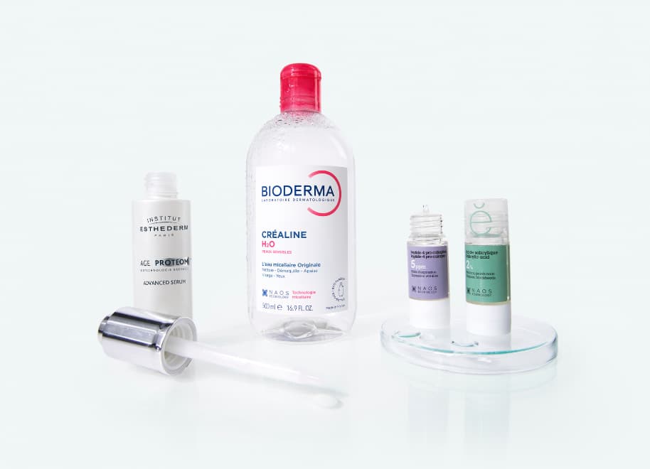 Naos brand best sellers: Bioderma Sensibio H2O micellar water, Institut Esthederm Age Proteom serum, and two Etat Pur treatments, salicylic acid and hyaluronic acid.